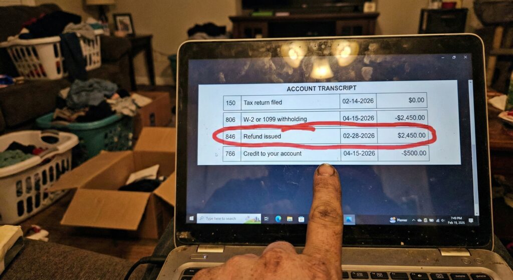 A close-up photo of a laptop screen showing an IRS tax transcript with code 846 circled in red marker.