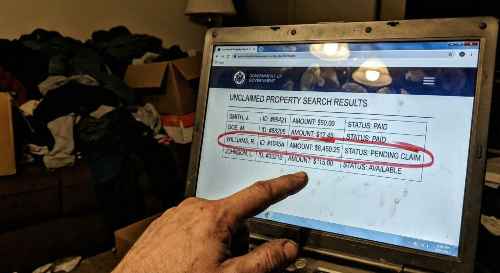 Gritty laptop screen in a dark room showing unclaimed property search results with a red circle around a $8,450.25 claim.